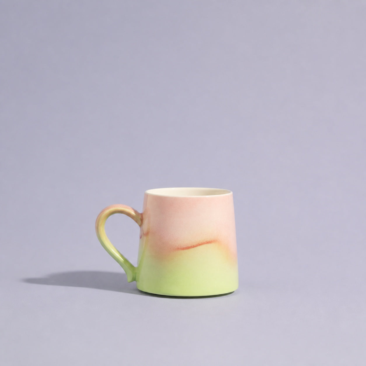 Cherry blush and spring-green mug from an alternate front angle